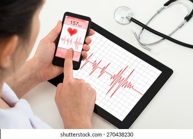 Close-up Of Doctor Holding Mobile Phone With App For Health