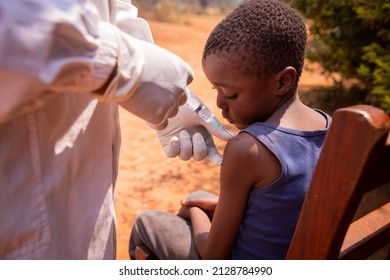 Close-up Of A Doctor Injecting The Vaccine To A Child In Africa.