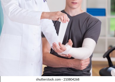 Closeup Of Doctor Making Cast Of Broken Upper Limb