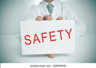 closeup of a doctor showing a signboard with the word safety written in it