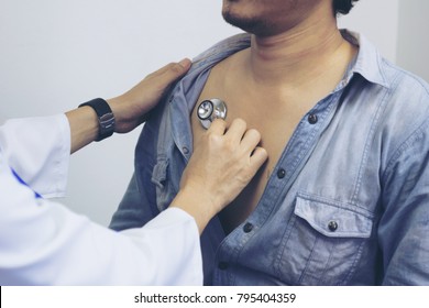 Closeup Of A Doctor With Stethoscope On The Chest Of Young Men