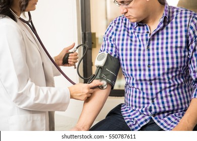 Closeup Of A Doctor Using A Blood Pressure Gauge On A Patient To Check On His Health