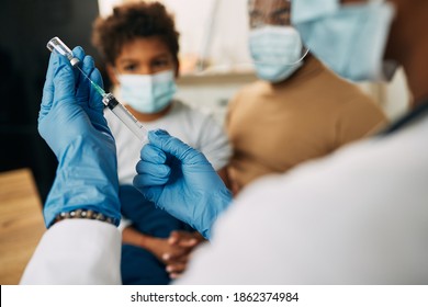 Close-up Of A Doctor Using Syringe And Preparing Medicine For A Child During Coronavirus Pandemic. 