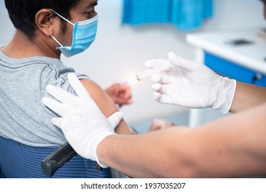 A close-up of a doctor vaccinating a patient's shoulder, influenza vaccination in the coronavirus arm, COVID-19 for vaccination.