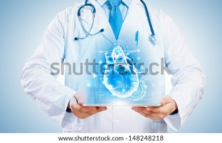 Close-up of doctor's body with tablet pc in hands