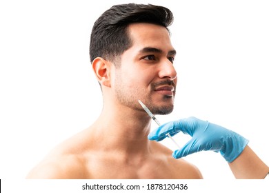 Closeup Of Doctor's Hands Giving Botox Injection Into The Skin Of Male Model On White Background