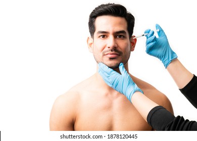 Closeup Of Doctor's Hands Injecting Botox Into The Skin Of Male Model On White Background