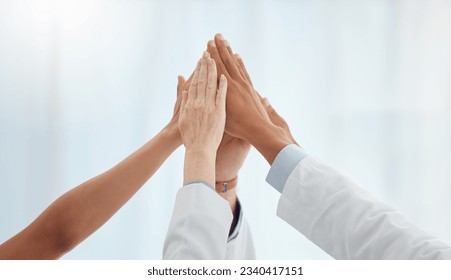 Closeup, doctors and nurses in hospital high five hands for team building success, motivation or healthcare support. Diversity, medical and people in achievement, collaboration and winner celebration - Powered by Shutterstock