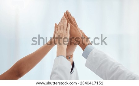 Closeup, doctors and nurses in hospital high five hands for team building success, motivation or healthcare support. Diversity, medical and people in achievement, collaboration and winner celebration