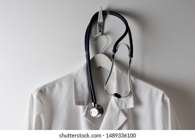 Closeup Of A Doctors White Lab Coat Hanging On A Hook With Stethoscope, Horizontal.