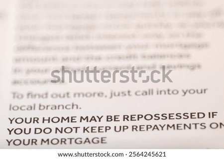 Close-up of a document with blurred text, focusing on a bold warning about mortgage repayments and potential home repossession.  The color scheme is primarily white and dark gray.