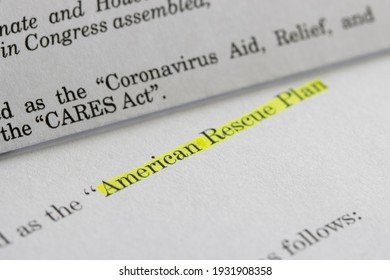 Closeup of the documents of both the Cares Act (Coronavirus Aid, Relief, and Economic Security Act) and the American Rescue Plan Act (ARPA) of 2021. - Shutterstock ID 1931908358