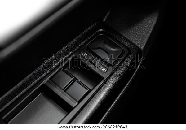 closeup of\
a door control panel in a new car. Arm rest with window control\
panel, door lock button, and mirror\
control.\
