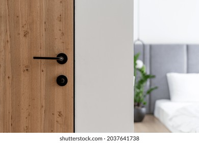 Closeup At Door Design, Open Room Interior. Minimalist House Style With Doorknob, Handle At Wooden Door. Entrance To Modern Bedroom, Nobody At Scandinavian Apartment.