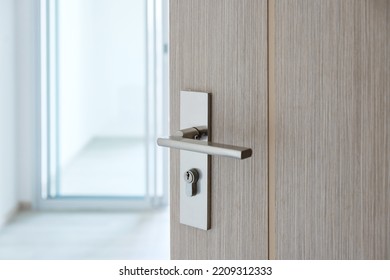 Closeup doorknob of wooden door between open or close the door