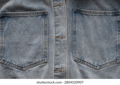Close-up of double denim jacket pockets