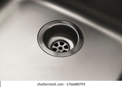 Close-up Of A Drain In A Steel Sink. Clean Sink, No Blockages. Water Supply.