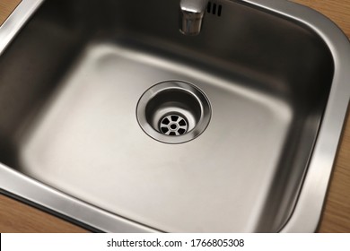 Close-up Of A Drain In A Steel Sink. Clean Sink, No Blockages. Water Supply.