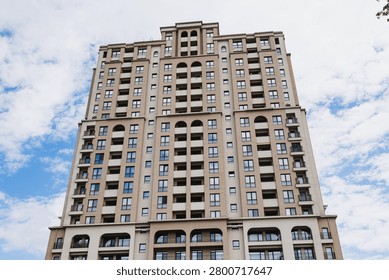 Closeup dramatic facade study emphasizing arches, stone balconies and repetitive window openings against bright sky. Strong focus on texture, ornament