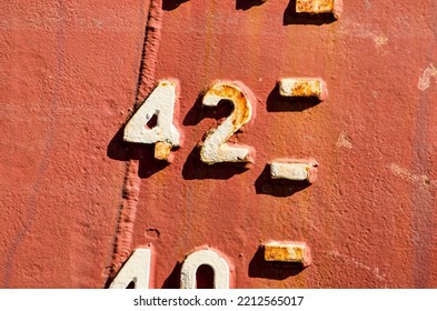 Close-up Of The Draught Marks On A Weathered Ship's Hull, Focussing On The Number 42