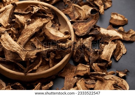 Close-up of dried porcini mushroom slices on moving platform