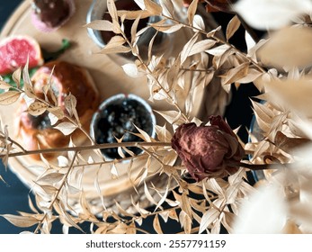 Close-up of dried roses in a vase, set against a breakfast table background with a warm and cozy atmosphere. - Powered by Shutterstock