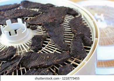 Closeup Of Dried Spiced Deer Jerky Slices On A Dehydrator