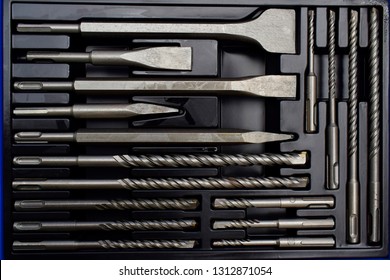Closeup of drill bits of different size in black toolbox. 
