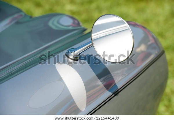 close-up of a\
driving mirror on a vintage\
vehicle