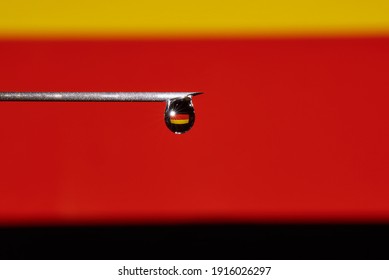 Close-up Of A Drop Of Vaccine With The Flag Of Germany On A Syringe Needle With Copy Space. 