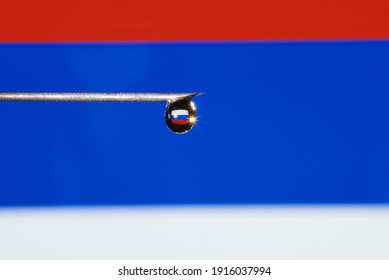 Close-up Of A Drop Of Vaccine With The Flag Of Russia On A Syringe Needle With Copy Space. 