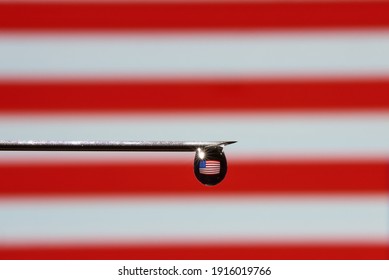 Close-up Of A Drop Of A Vaccine With A Flag USA On A Syringe Needle With Copy Space.