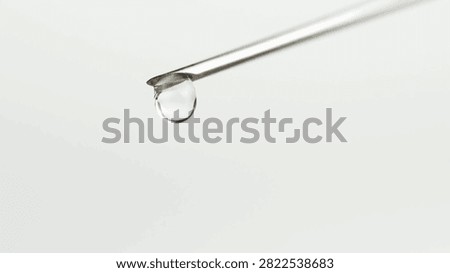 closeup droplets of clear liquid fall and spurt from syringe. medication medical syringe for injection with medicine anesthesiology vaccination CU