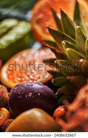 Close-up droplets of water on passion fruits, evergreen tropical pineapple leaves with shalow depth of field. Exotic tropical vegetarian concept background.
