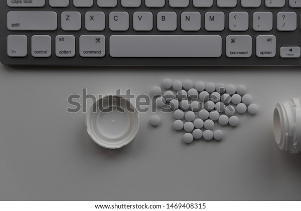 Closeup Dropped Medication Pills Computer Desk Stock Image