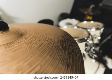 Close-up of drum bronze cymbal plate in music studio. High quality photo