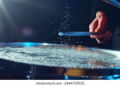 Close-up of drum with water drops jumping from stick's strike. Creative and impressive live performance. Concept of music, instruments, concert, sound, equipment, festival - Powered by Shutterstock