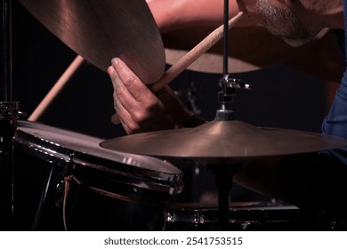 Close-up of drummer playing cymbals during live performance. - Powered by Shutterstock