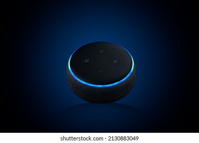 A closeup of an Echo Dot, Voice assistant on dark blue background