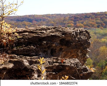 Closeup Of The Edge Of A Cliff With A Colorful Blurred Background Of Hills With Autumn Trees