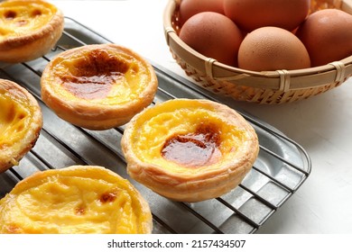 Closeup of Egg tart or portuguese egg tart. golden delicious new baked tart with egg on wooden table.