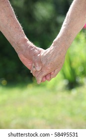 Closeup of elderly couple holding hands