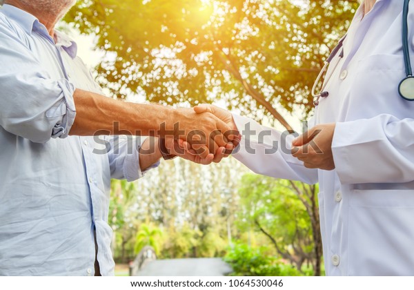 closeup-elderly-doctor-woman-shake-hands-stock-photo-edit-now-1064530046