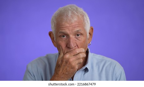 Closeup Of Elderly Senior Handsome Man Thinking Searching For Idea, Isolated On A Purple Solid Background.