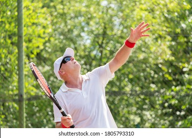 Close-up Of An Elderly Tennis Player Playing Tennis On An Outdoor Court