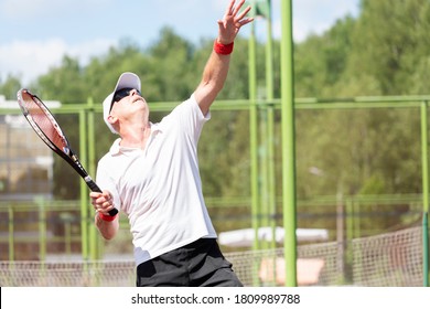 Close-up Of An Elderly Tennis Player Playing Tennis On An Outdoor Court