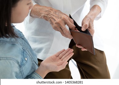 Closeup Elderly Woman Hands Open Wallet,grandmother Or Guardian Giving Pocket Money To Granddaughter,asian Little Girl Demanding Money,parent Pulls Out Money From Wallet To Give Her