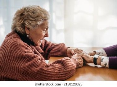 Close-up Of An Elderly Woman Holding The Hands Of Another Woman. Only One Person Is Visible. Concept Of Care And Affection In Old Age. Nursing Home.