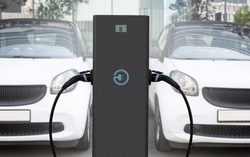 Close-up Of A Electric Charging Station On The Background Of Cars