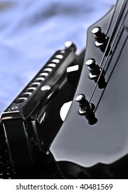 Close-up Of Electric Guitar Headstock And Harmonica